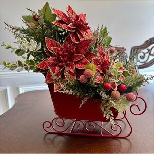 Elegant Red Sleigh with Poinsettias and Greenery